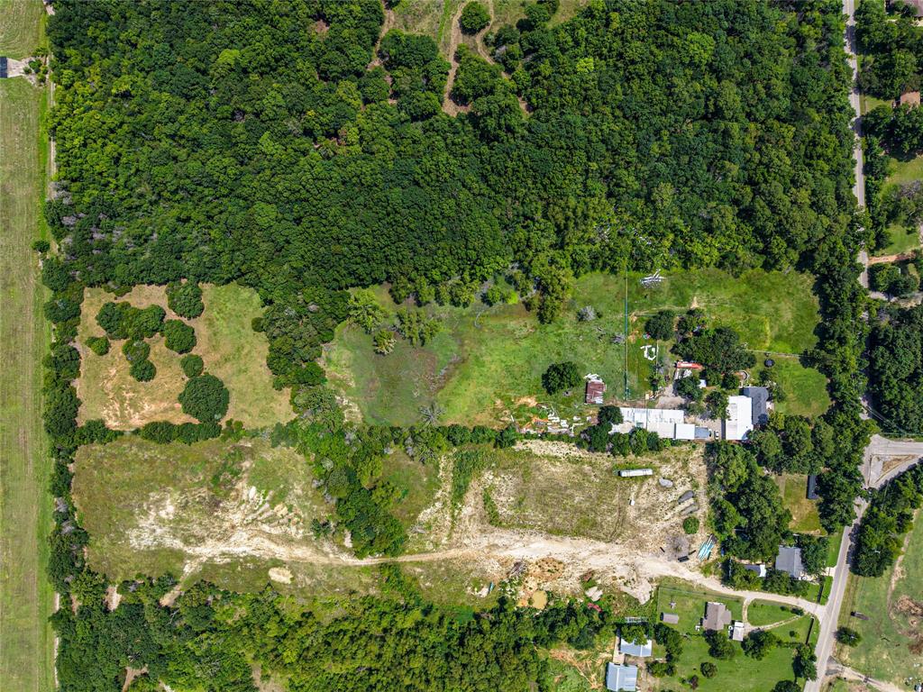 1900 Haymarket Road Dallas, TX 75253 - Photo 6 of 20 Expansive land parcel featuring dense tree coverage, multiple clearings, and existing structures