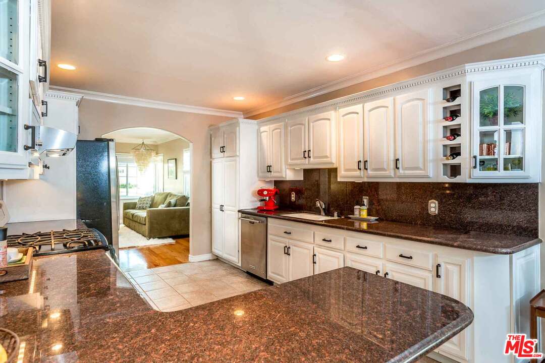 7418 Midfield Avenue Los Angeles, CA 90045 - Photo 12 of 28 a kitchen with granite countertop a stove a sink and a refrigerator