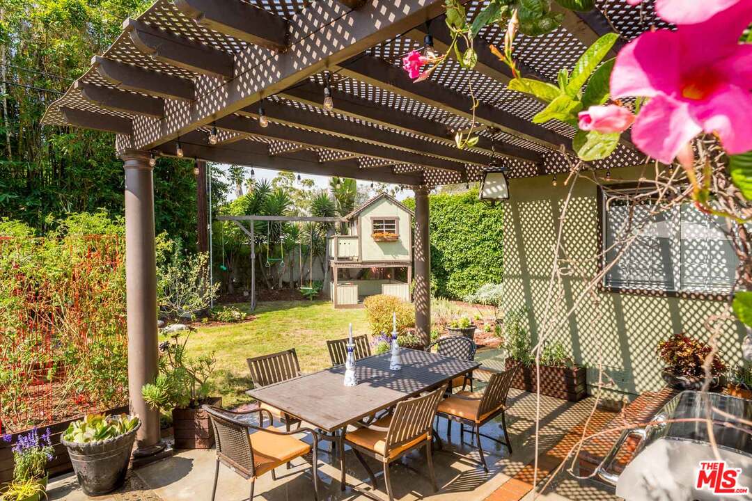 7418 Midfield Avenue Los Angeles, CA 90045 - Photo 22 of 28 a view of a patio with table and chairs potted plants and floor to ceiling window