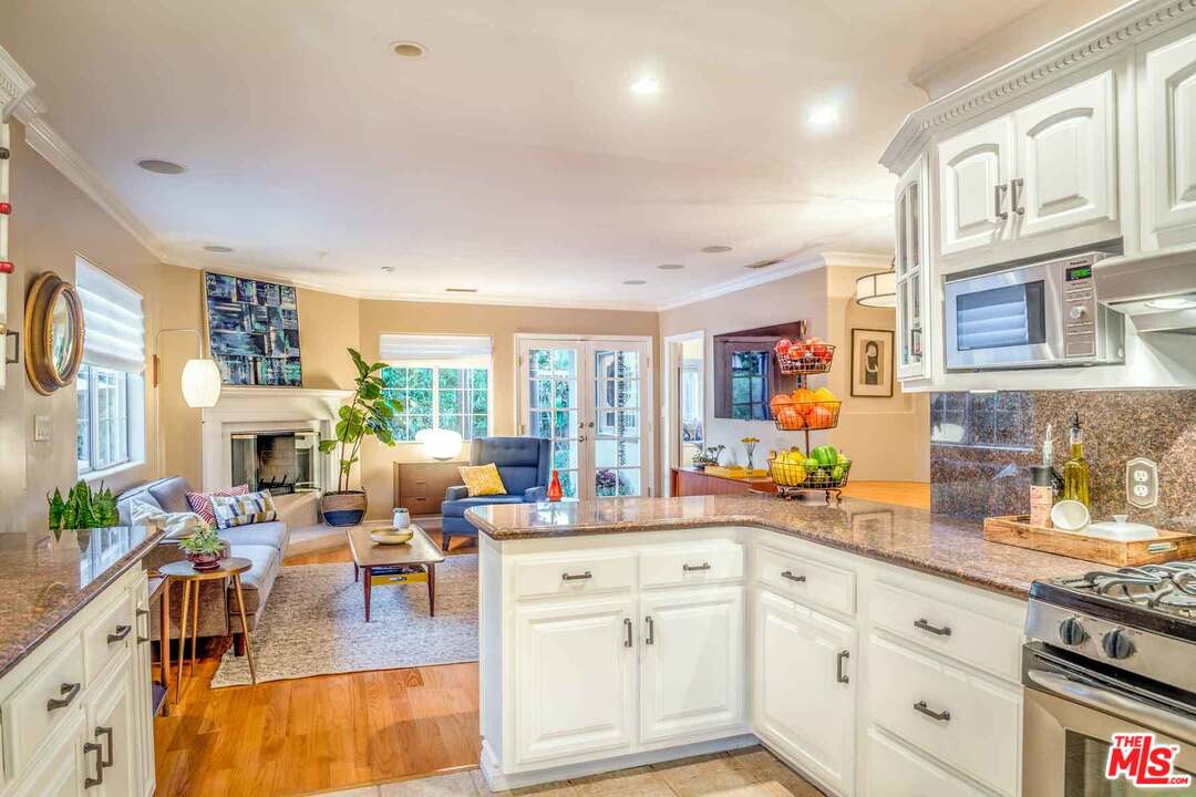 7418 Midfield Avenue Los Angeles, CA 90045 - Photo 4 of 28 a view of living room kitchen with stainless steel appliances granite countertop cabinets and a couch