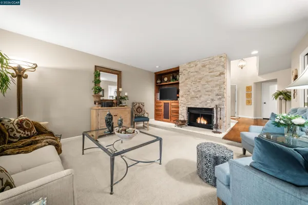 a living room with furniture and a fireplace