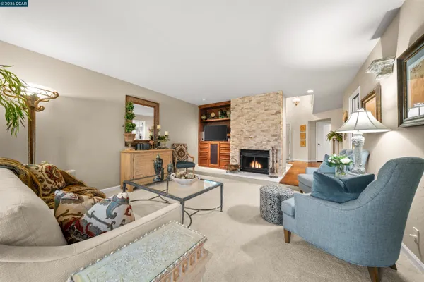 a living room with furniture and a fireplace