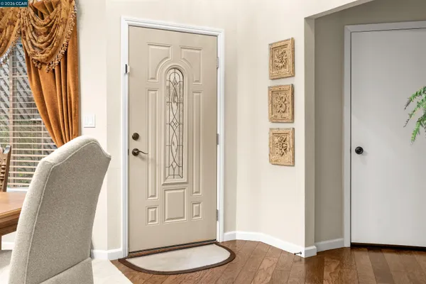 a view of a bedroom with wooden floor and door