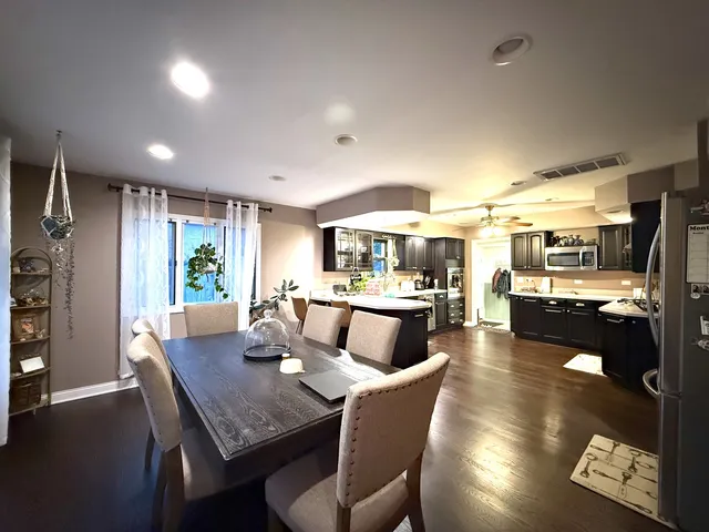 a dining room with furniture and wooden floor