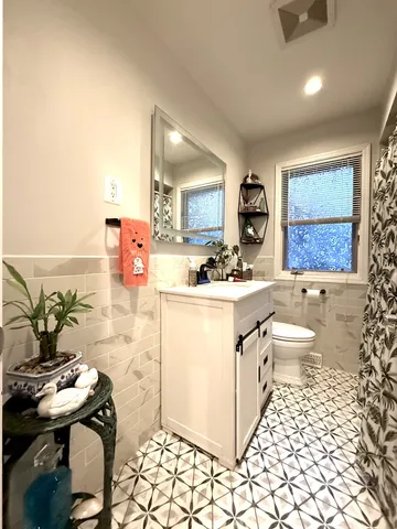 a bathroom with a sink a toilet and mirror