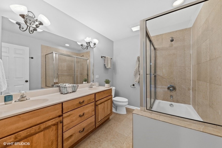 411 South Wilke Road Arlington Heights, IL 60005 - Photo 13 of 29 a bathroom with a double vanity sink mirror and toilet