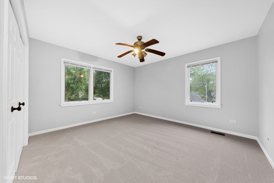 411 South Wilke Road Arlington Heights, IL 60005 - Photo 14 of 29 an empty room with a window and a ceiling fan