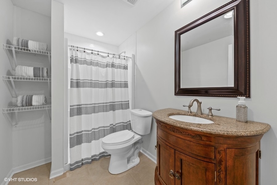 411 South Wilke Road Arlington Heights, IL 60005 - Photo 18 of 29 a bathroom with a toilet sink and mirror