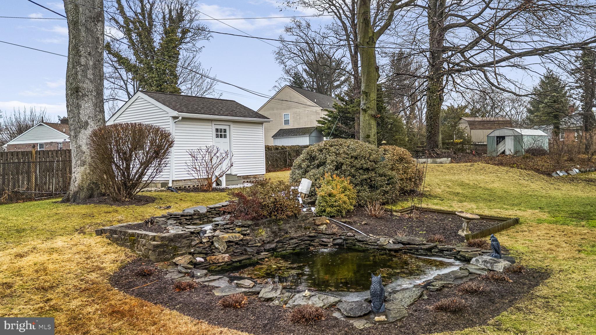 711 Elgin Road Newtown Square, PA 19073 - Photo 29 of 36 Backyard with shed and koi pond
