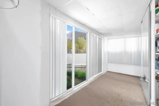a view of an empty room with glass door