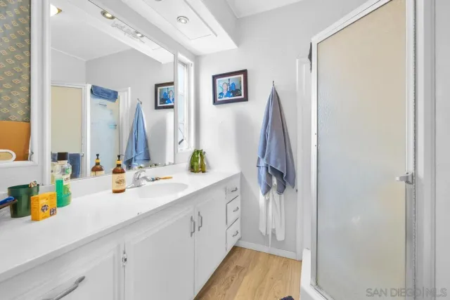 a spacious bathroom with a double vanity sink and a mirror