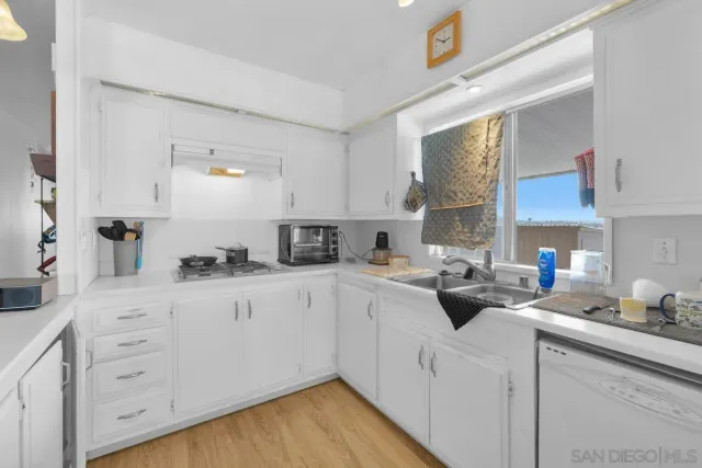 a kitchen with cabinets a sink and appliances