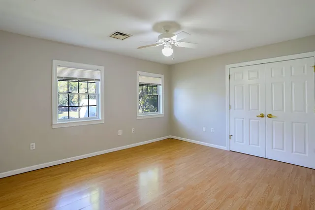 a view of hallway with wooden floor