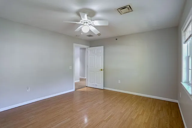 wooden floor in a hall with an empty room