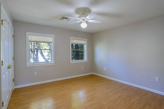a view of a room with wooden floor
