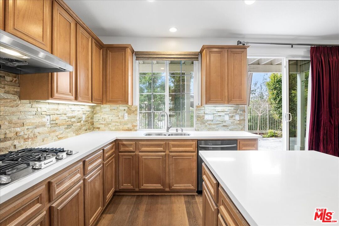 5 Sachem Way Ladera Ranch, CA 92694 - Photo 23 of 37 a kitchen with a sink stove and cabinets