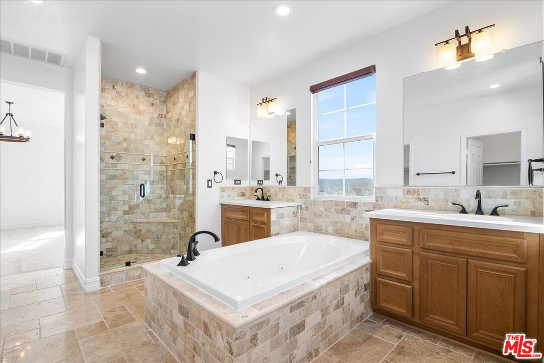 5 Sachem Way Ladera Ranch, CA 92694 - Photo 34 of 37 a spacious bathroom with a tub sink and mirror