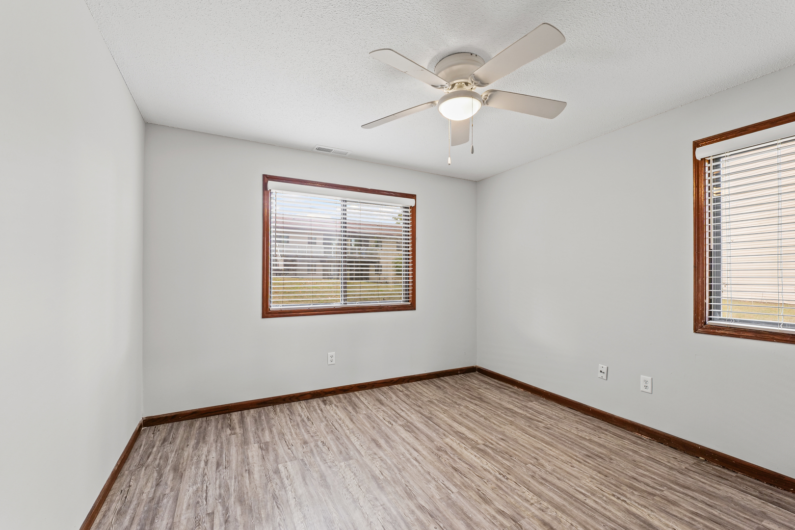 1302 Christopher Circle, Unit 4 Urbana, IL 61802 - Photo 11 of 17 an empty room with wooden floor and windows