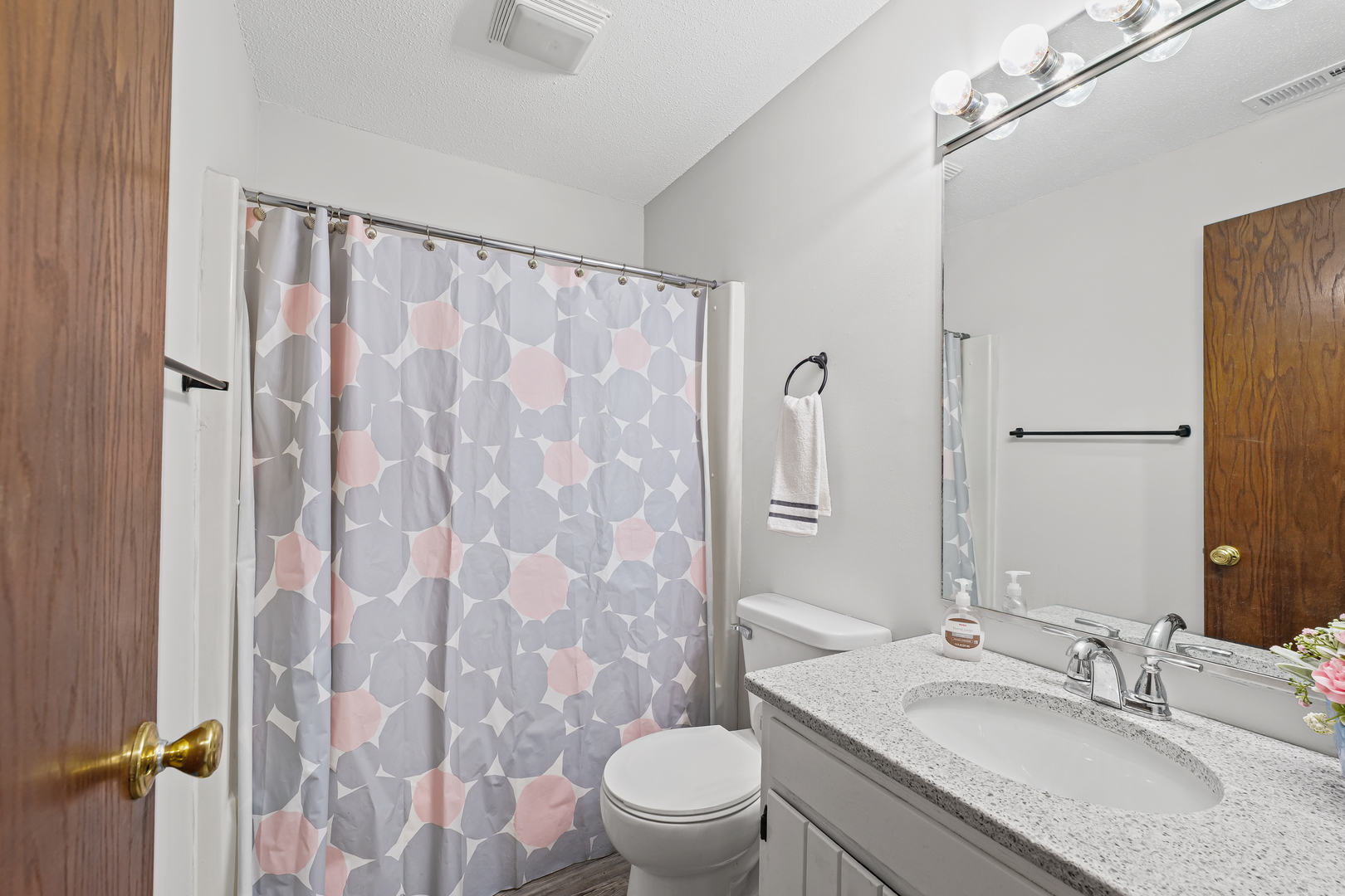 1302 Christopher Circle, Unit 4 Urbana, IL 61802 - Photo 5 of 17 a bathroom with a granite countertop sink toilet and shower