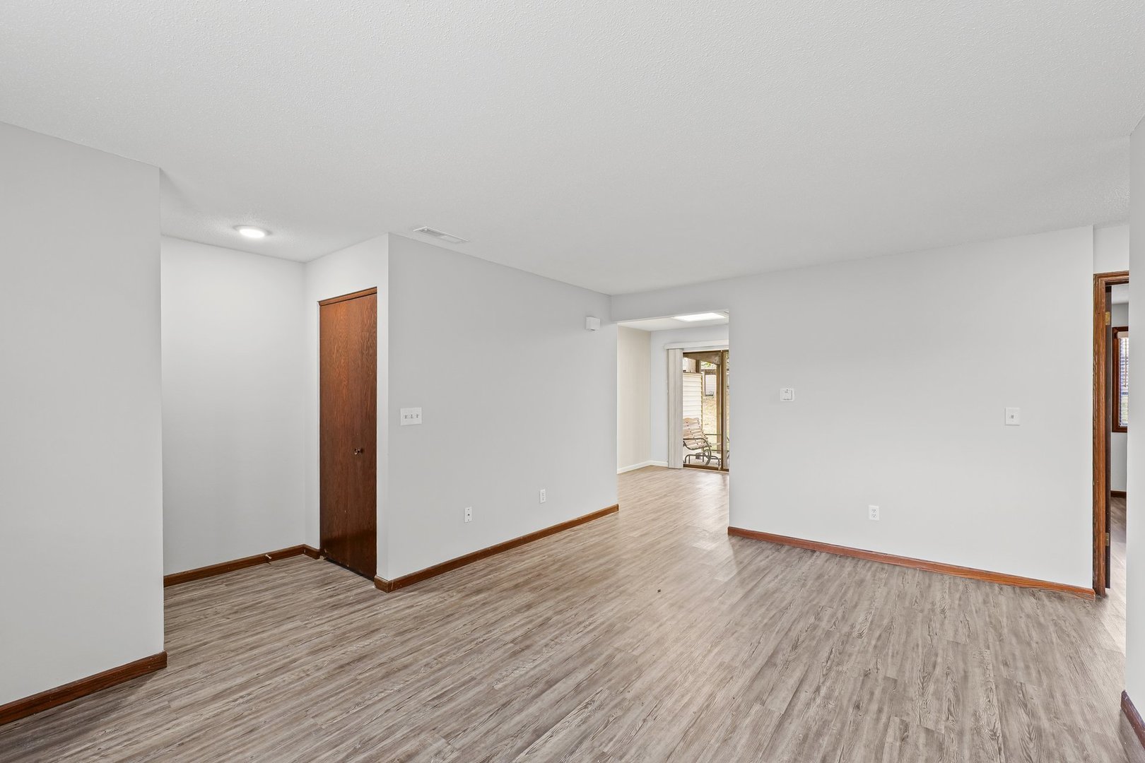 1302 Christopher Circle, Unit 4 Urbana, IL 61802 - Photo 8 of 17 an empty room with wooden floor and windows