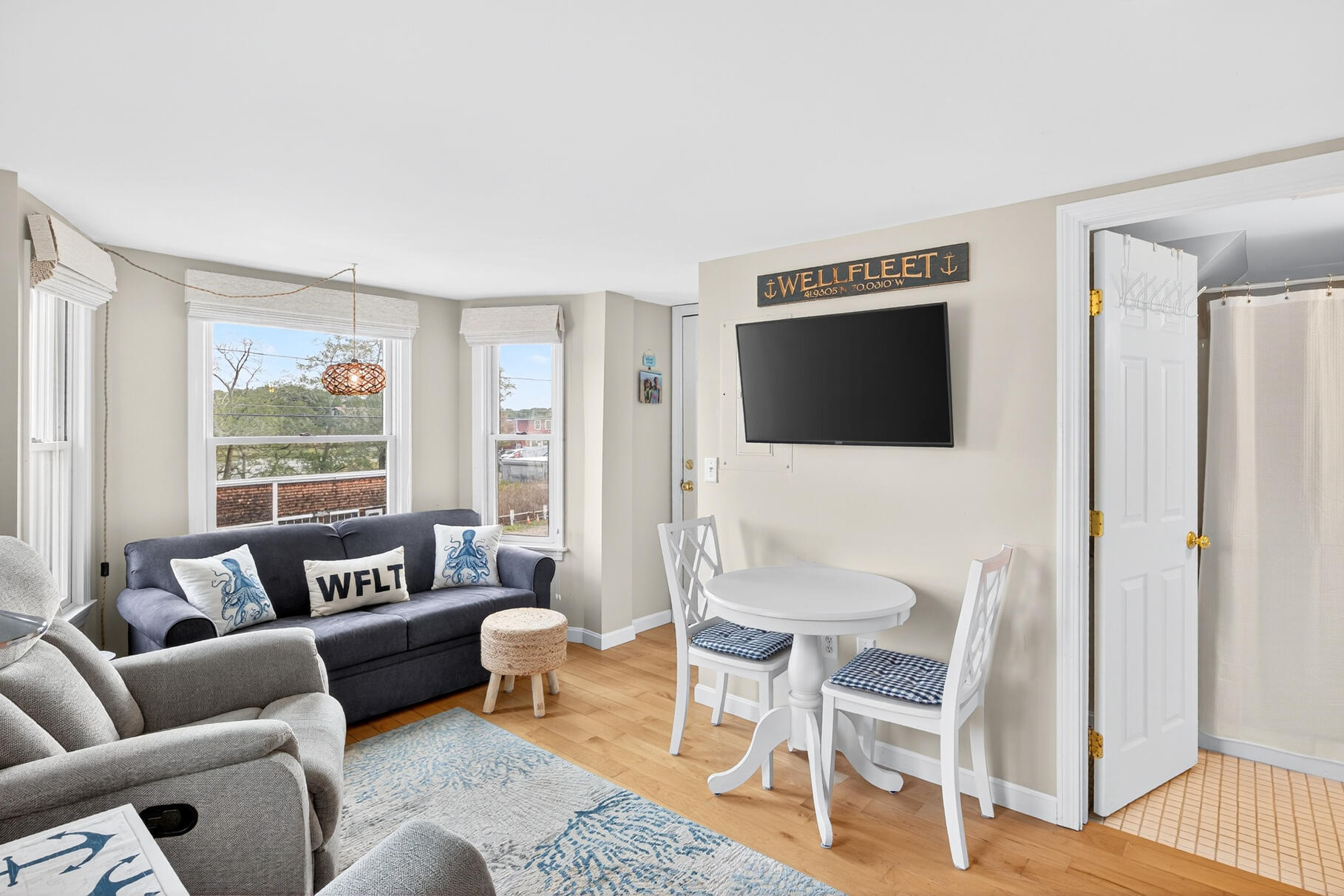 70 Commercial Street, Unit C Wellfleet, MA 02667 - Photo 12 of 32 a living room with furniture and a flat screen tv