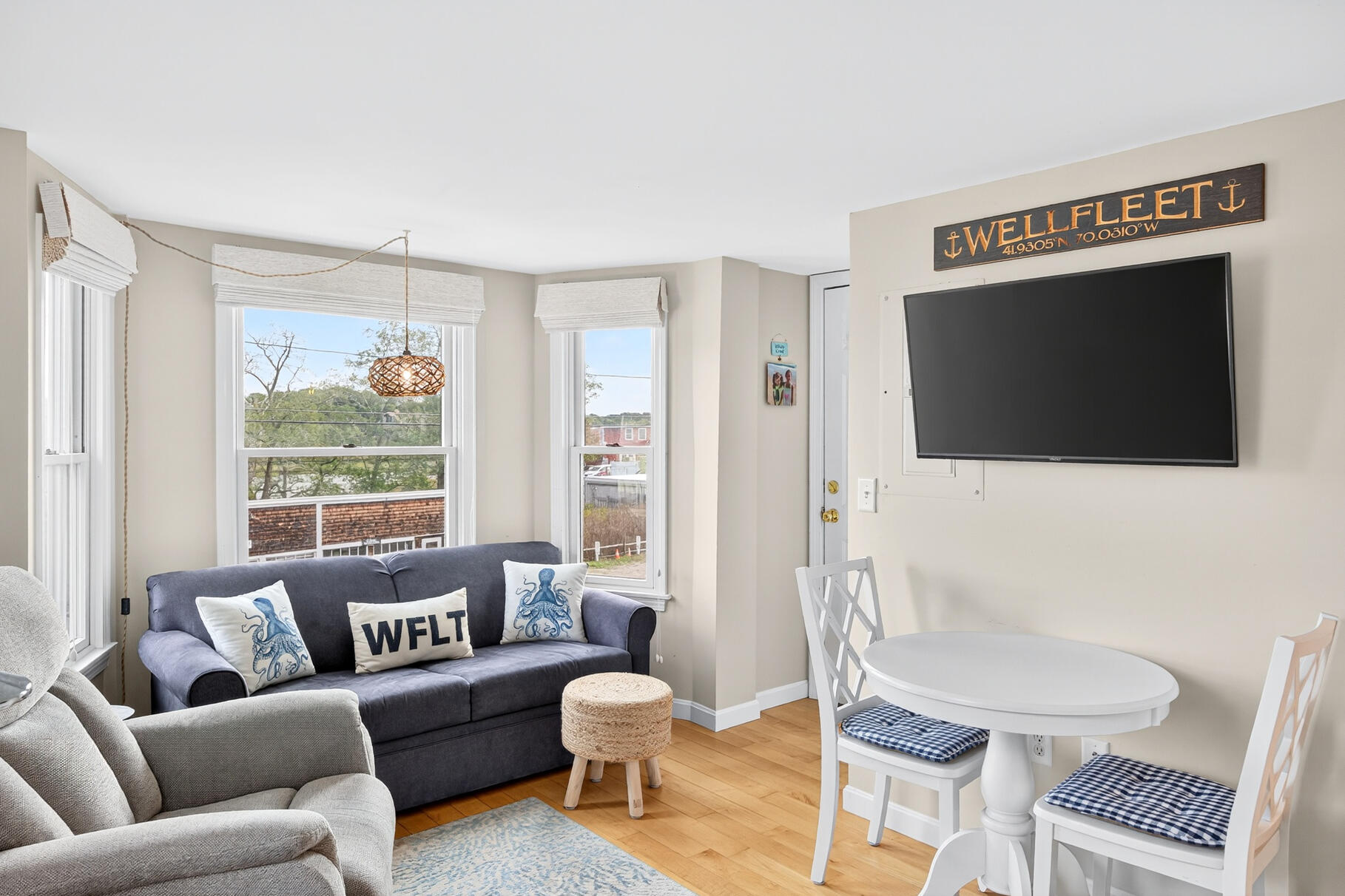 70 Commercial Street, Unit C Wellfleet, MA 02667 - Photo 15 of 32 a living room with furniture a flat screen tv and a window