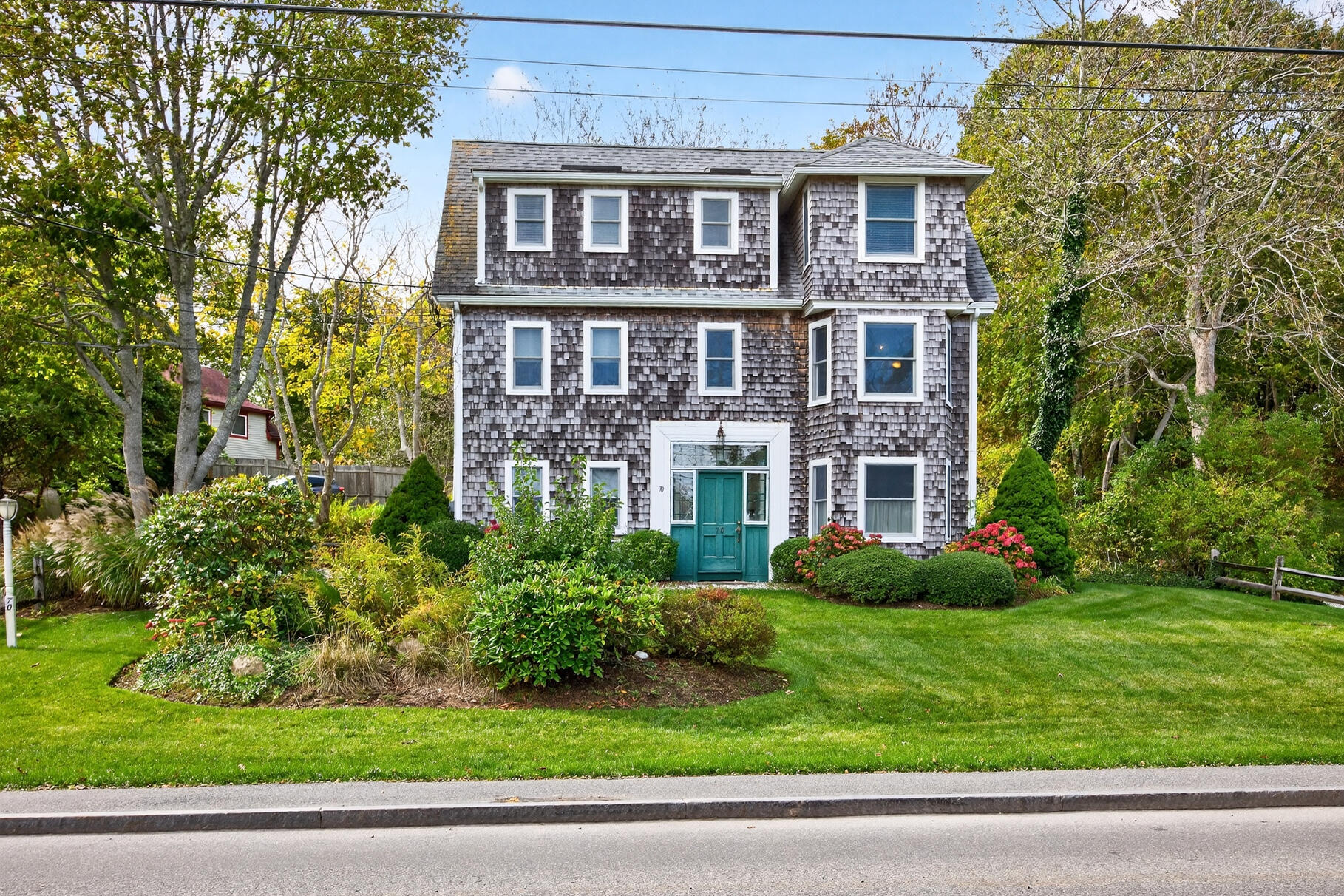70 Commercial Street, Unit C Wellfleet, MA 02667 - Photo 22 of 32 a front view of a house with a yard