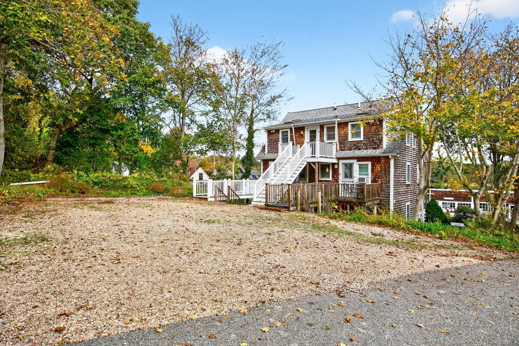 70 Commercial Street, Unit C Wellfleet, MA 02667 - Photo 25 of 32 a front view of a house with a yard