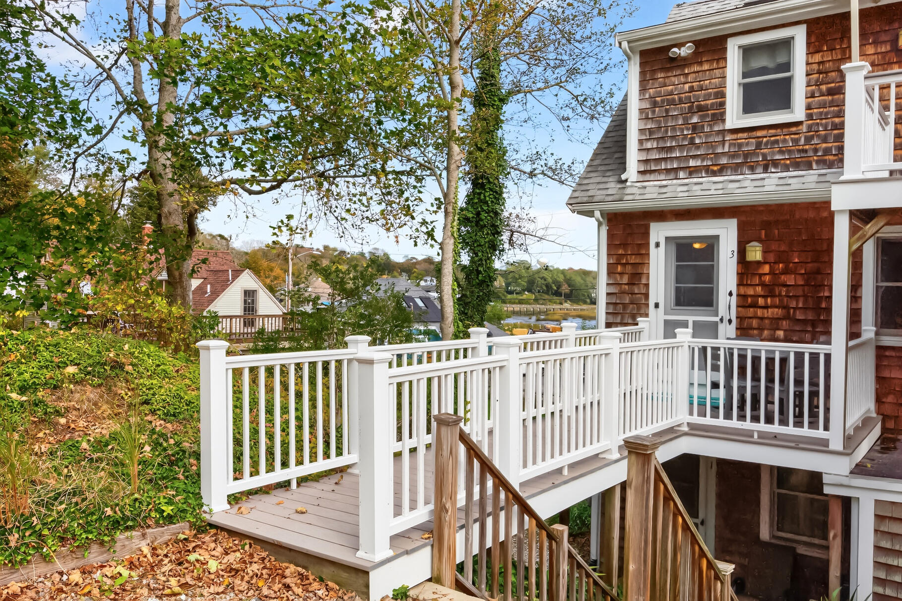 70 Commercial Street, Unit C Wellfleet, MA 02667 - Photo 27 of 32 a view of a brick house with a small yard
