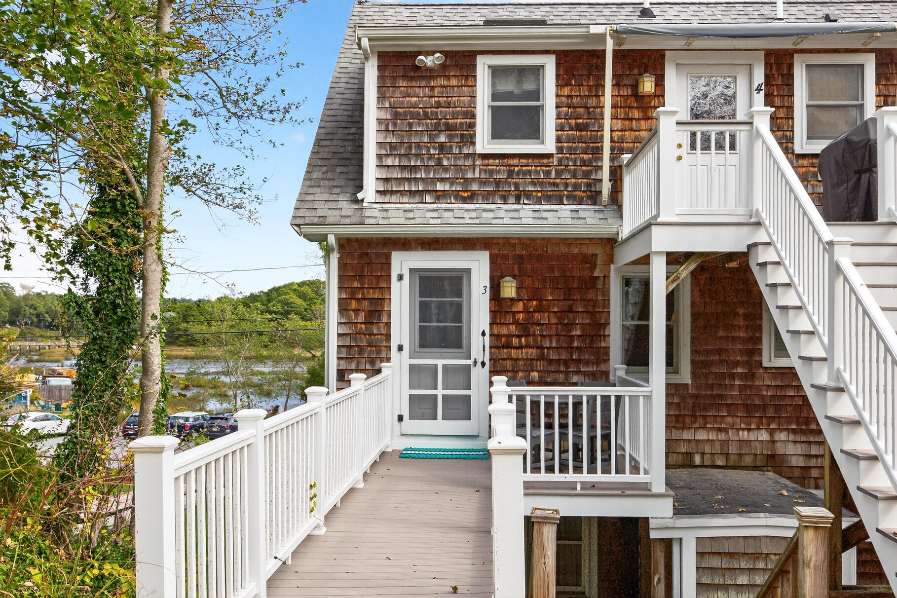 70 Commercial Street, Unit C Wellfleet, MA 02667 - Photo 28 of 32 a front view of a house with a porch