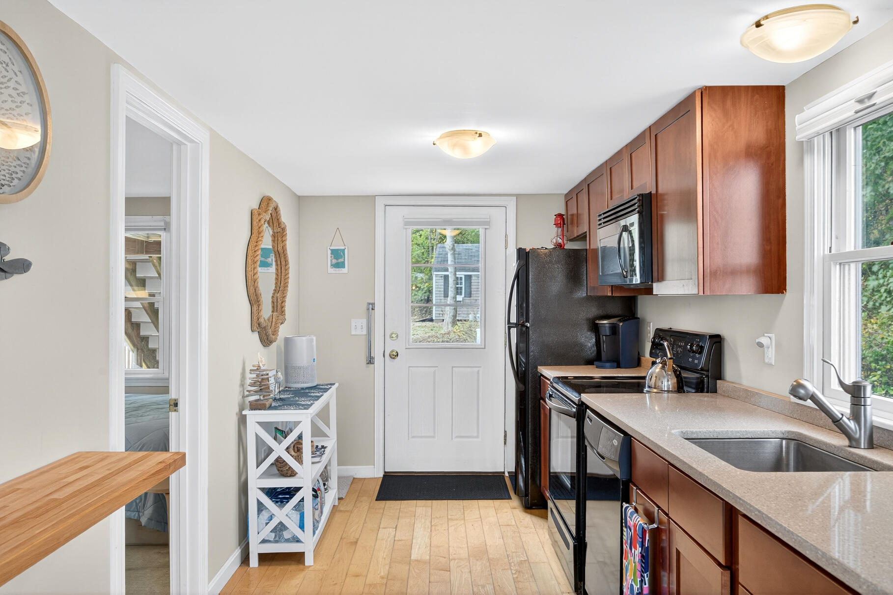 70 Commercial Street, Unit C Wellfleet, MA 02667 - Photo 5 of 32 a kitchen with stainless steel appliances granite countertop a sink a stove and a refrigerator