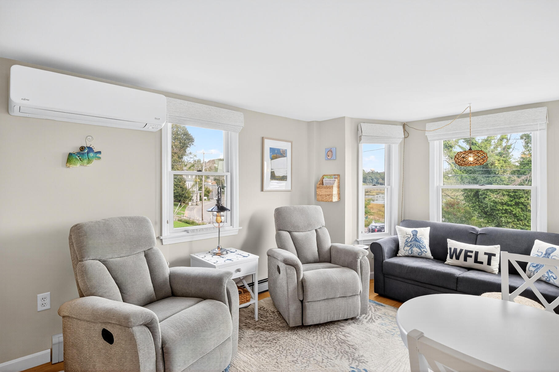 70 Commercial Street, Unit C Wellfleet, MA 02667 - Photo 8 of 32 a living room with furniture and a large window