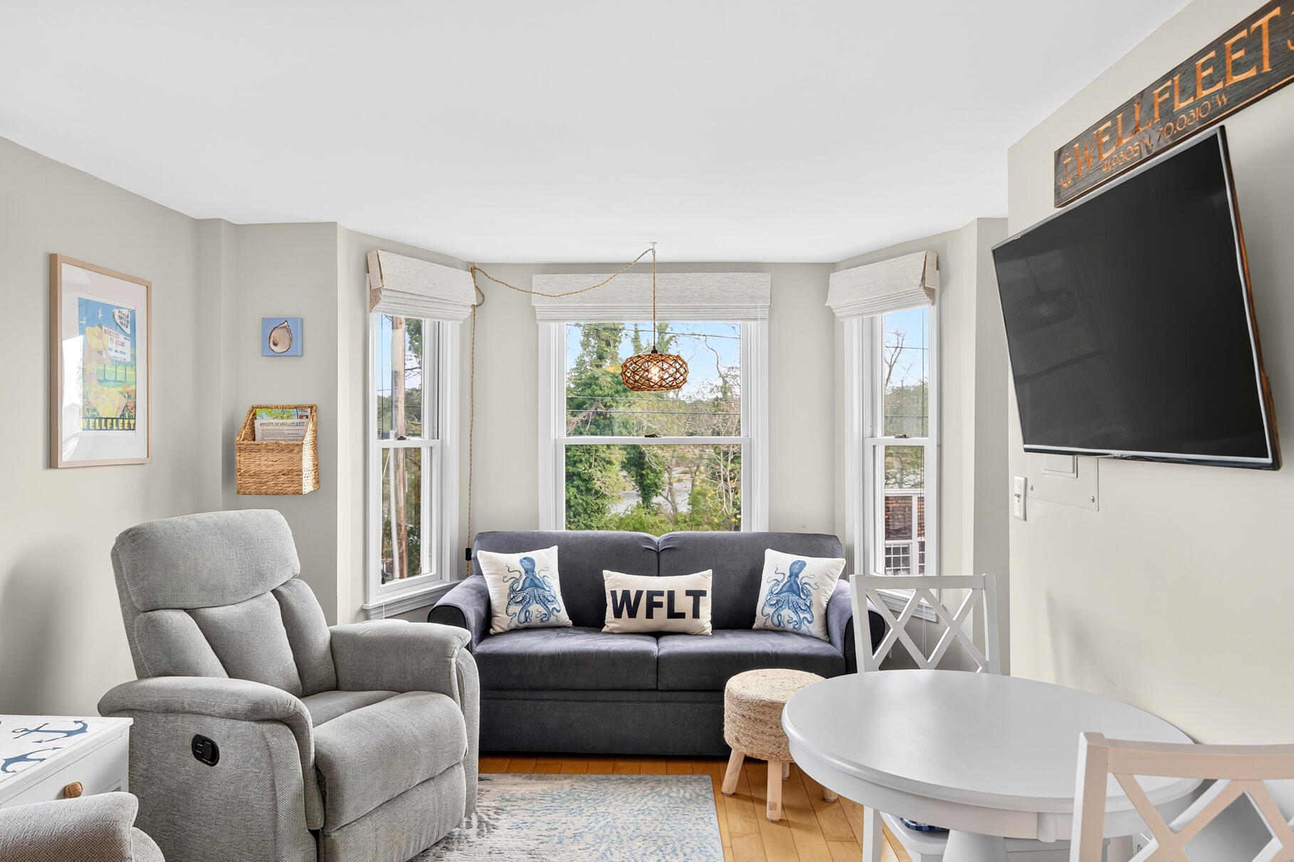 70 Commercial Street, Unit C Wellfleet, MA 02667 - Photo 10 of 32 a living room with furniture a flat screen tv and a window