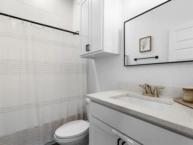 a spacious bedroom with a bed and a window