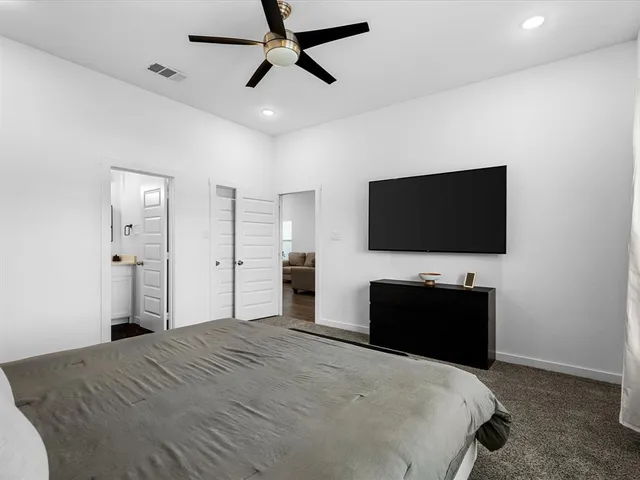 a hallway with wooden floor and windows