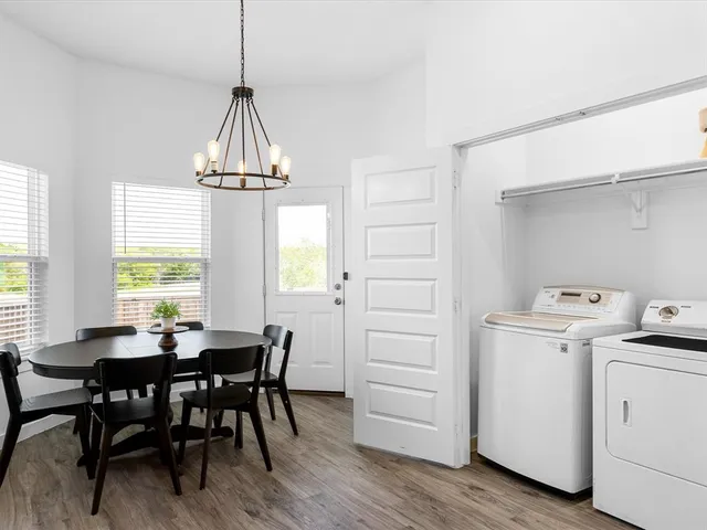a view of a dining room with furniture and a chandelier
