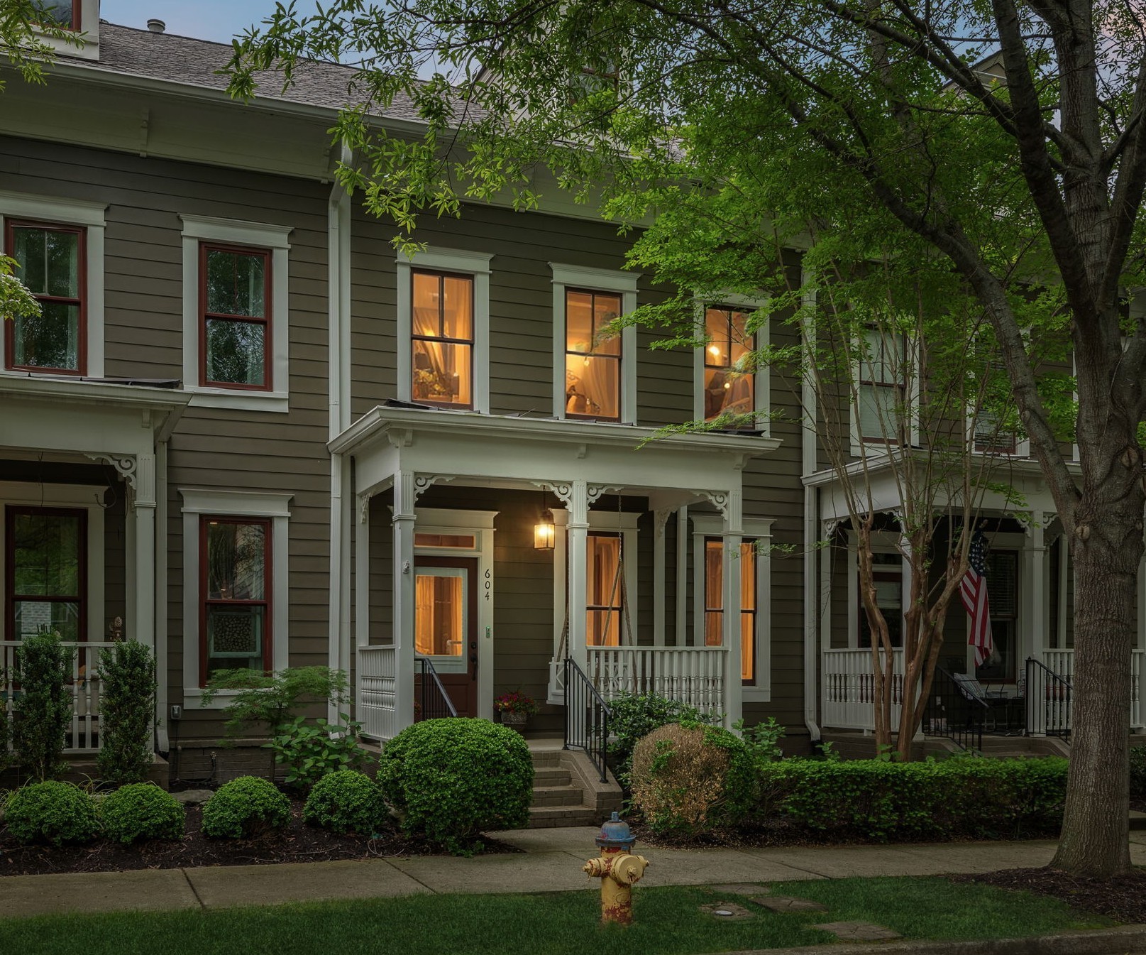 604 Watermark Way Franklin, TN 37064 - Photo 30 of 37 a view of a brick house with large windows and a yard with plants and large trees