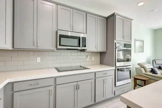 a kitchen with cabinets appliances a sink and a counter space