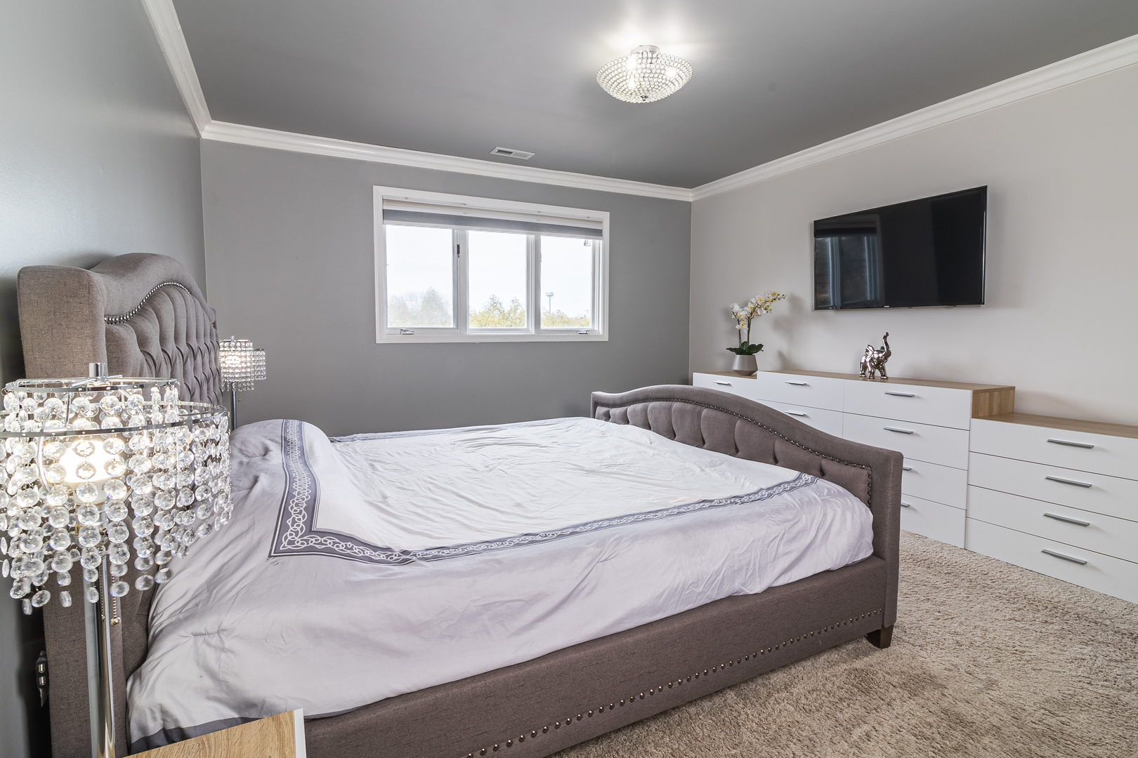 6317 Clarendon Hills Road, Unit 2 Willowbrook, IL 60527 - Photo 11 of 21 a bedroom with a bed and a flat screen tv