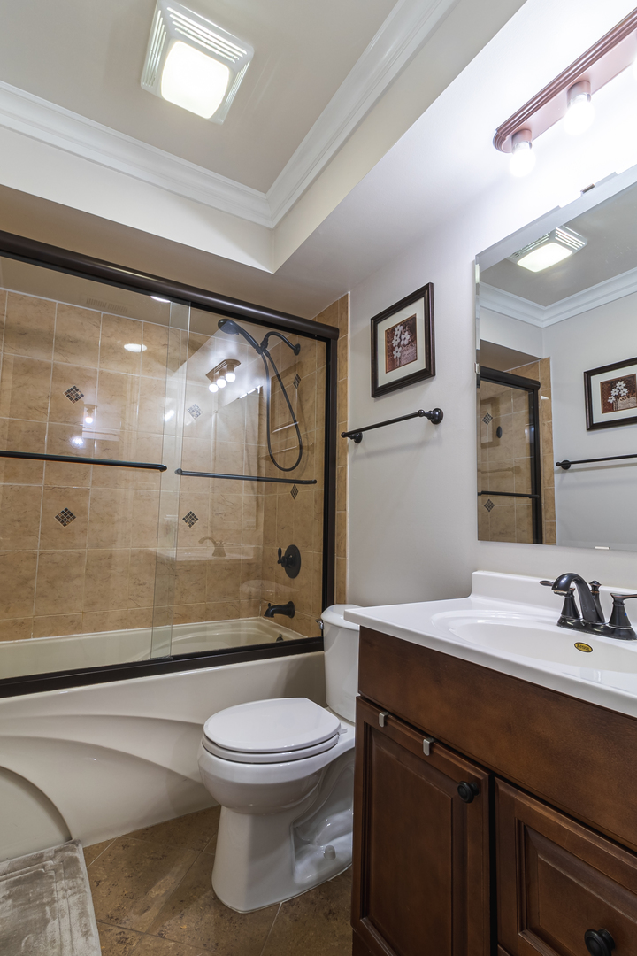 6317 Clarendon Hills Road, Unit 2 Willowbrook, IL 60527 - Photo 14 of 21 a bathroom with a sink a toilet and shower