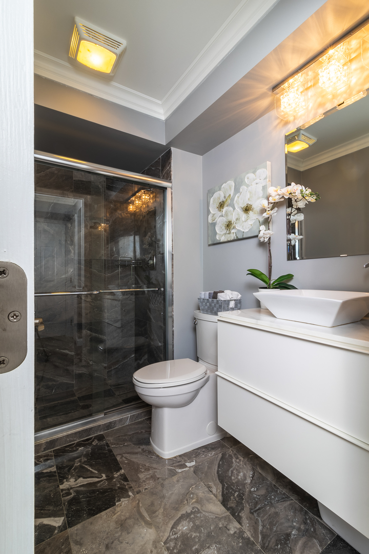 6317 Clarendon Hills Road, Unit 2 Willowbrook, IL 60527 - Photo 8 of 21 a bathroom with a sink toilet and shower