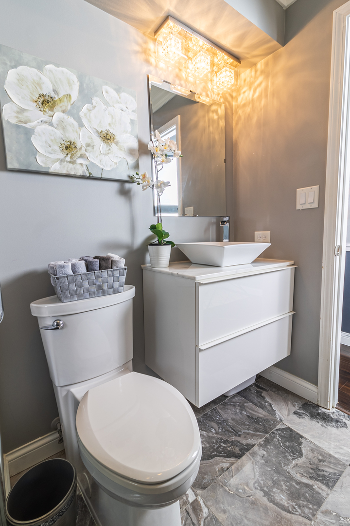 6317 Clarendon Hills Road, Unit 2 Willowbrook, IL 60527 - Photo 9 of 21 a bathroom with a toilet sink and mirror