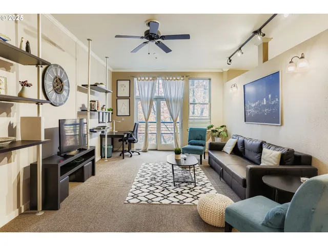 a living room with furniture a chandelier and a window