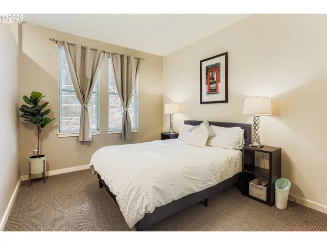 a bedroom with a bed and a potted plant