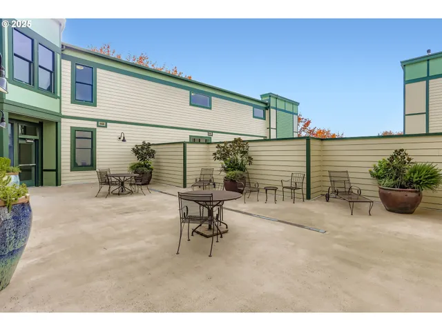 a view of a patio with table and chairs and potted plants