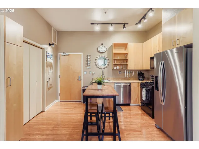 a kitchen with cabinets and stainless steel appliances