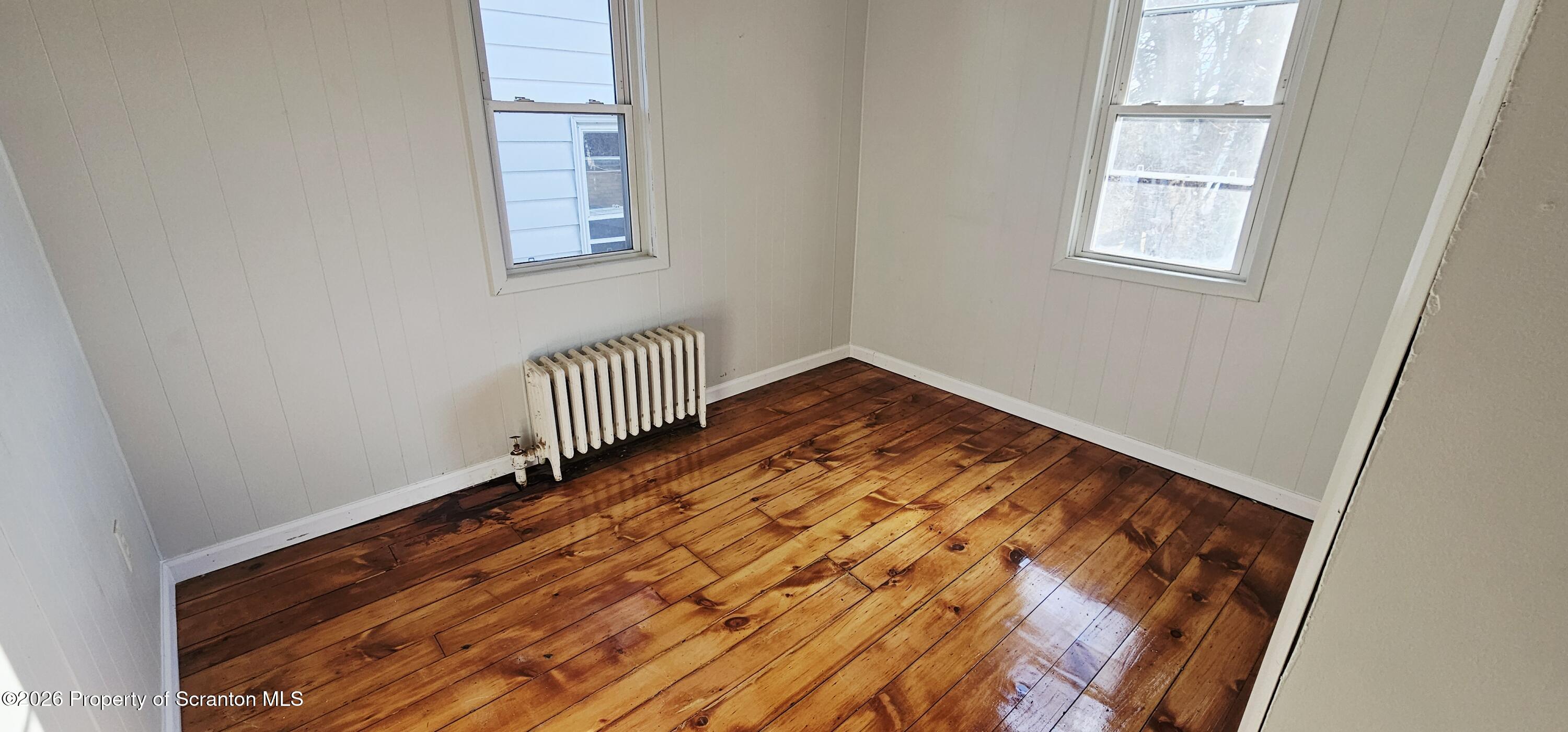 1919 Price Street Scranton, PA 18504 - Photo 17 of 20 an empty room with wooden floor and windows