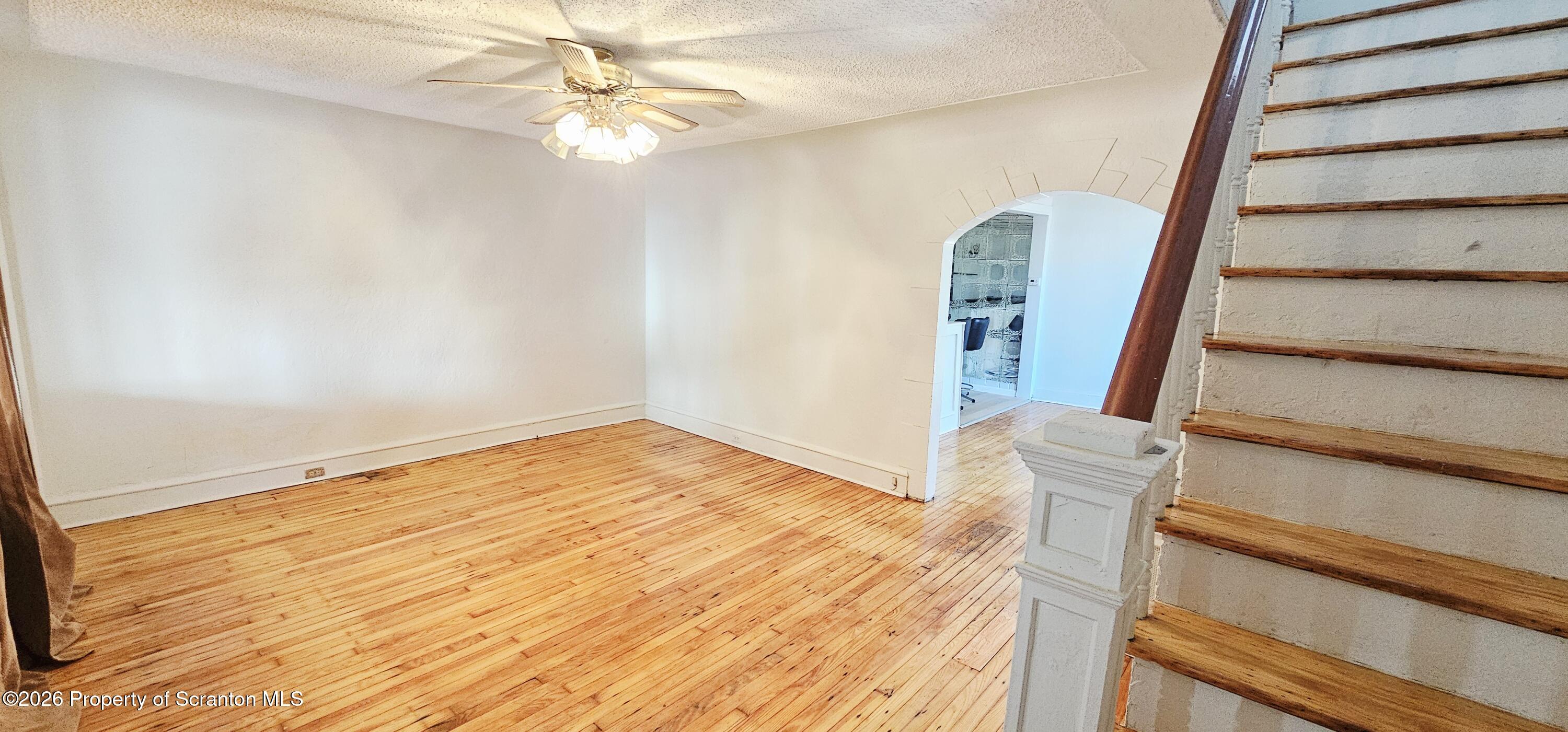 1919 Price Street Scranton, PA 18504 - Photo 2 of 20 a view of a room with wooden floor and white walls