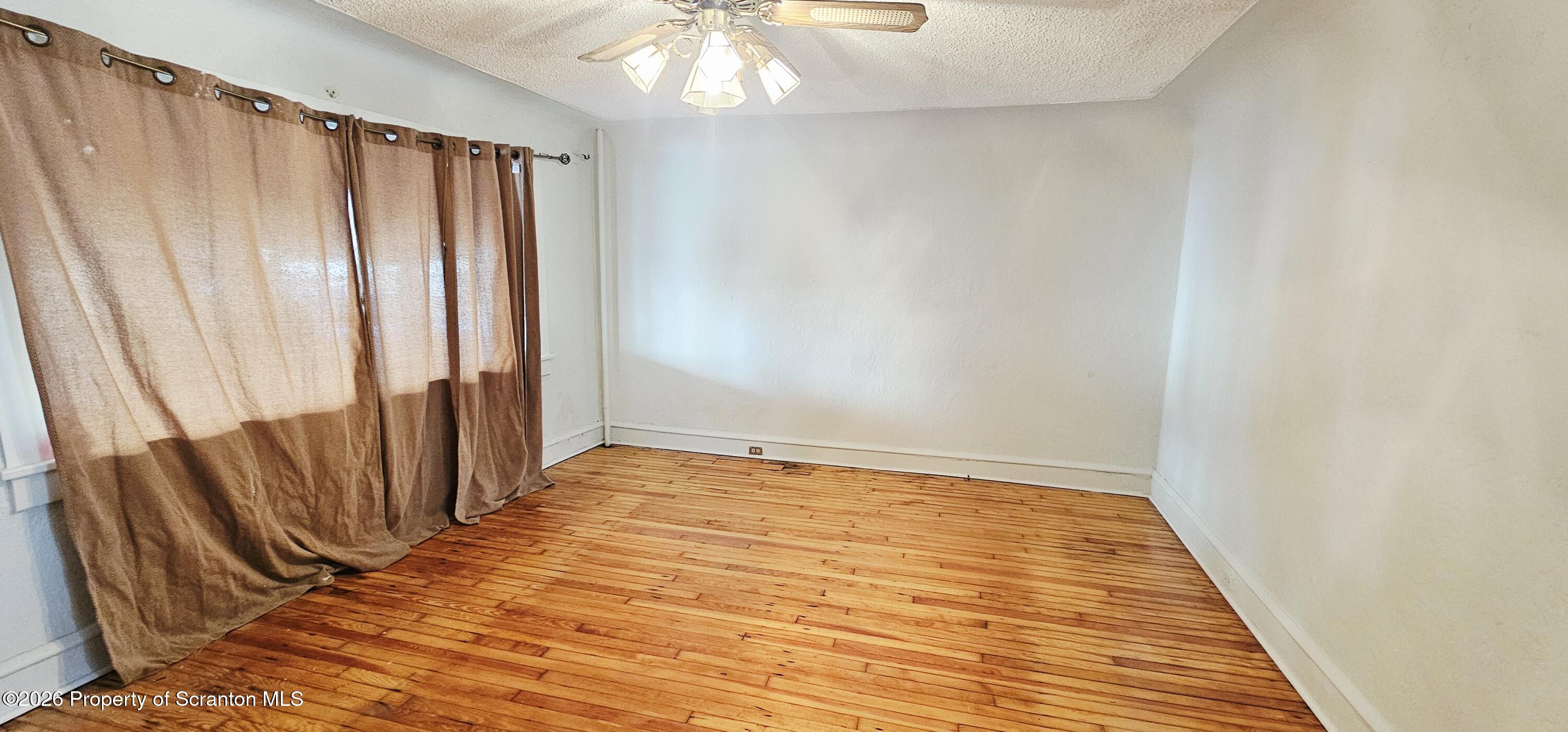 1919 Price Street Scranton, PA 18504 - Photo 4 of 20 a view of an empty room with wooden floor