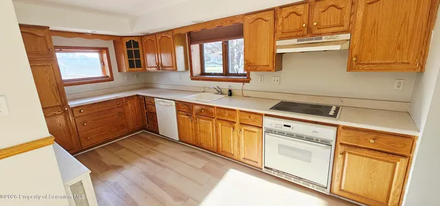 a kitchen with granite countertop cabinets stainless steel appliances a sink and a window